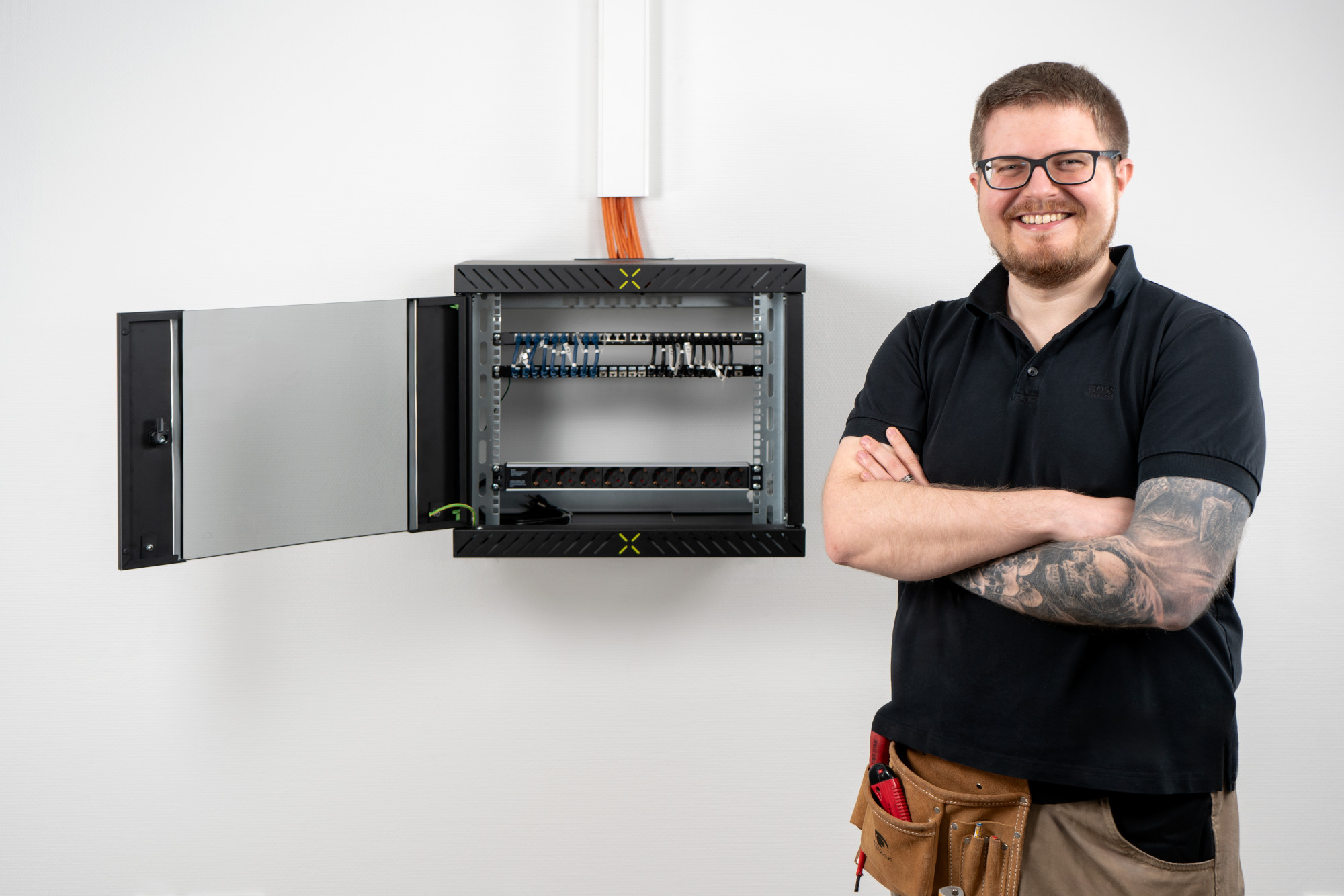 Man posing in front of fully assembled X-Rack with door open Man posing in front of fully assembled X-Rack with door open
