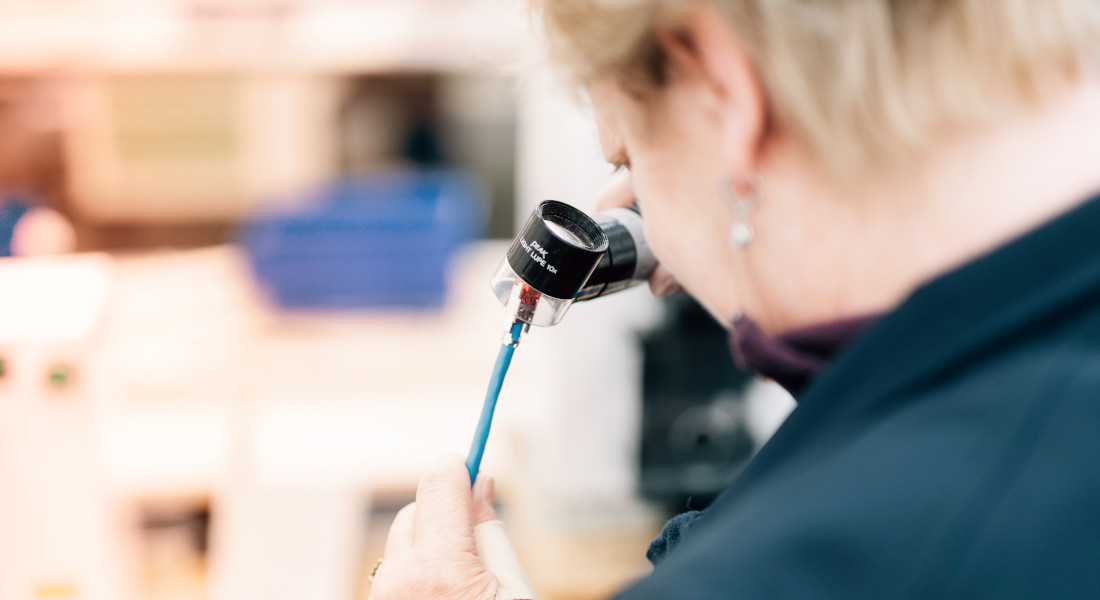 Woman inspecting cable, EFB-Elektronik