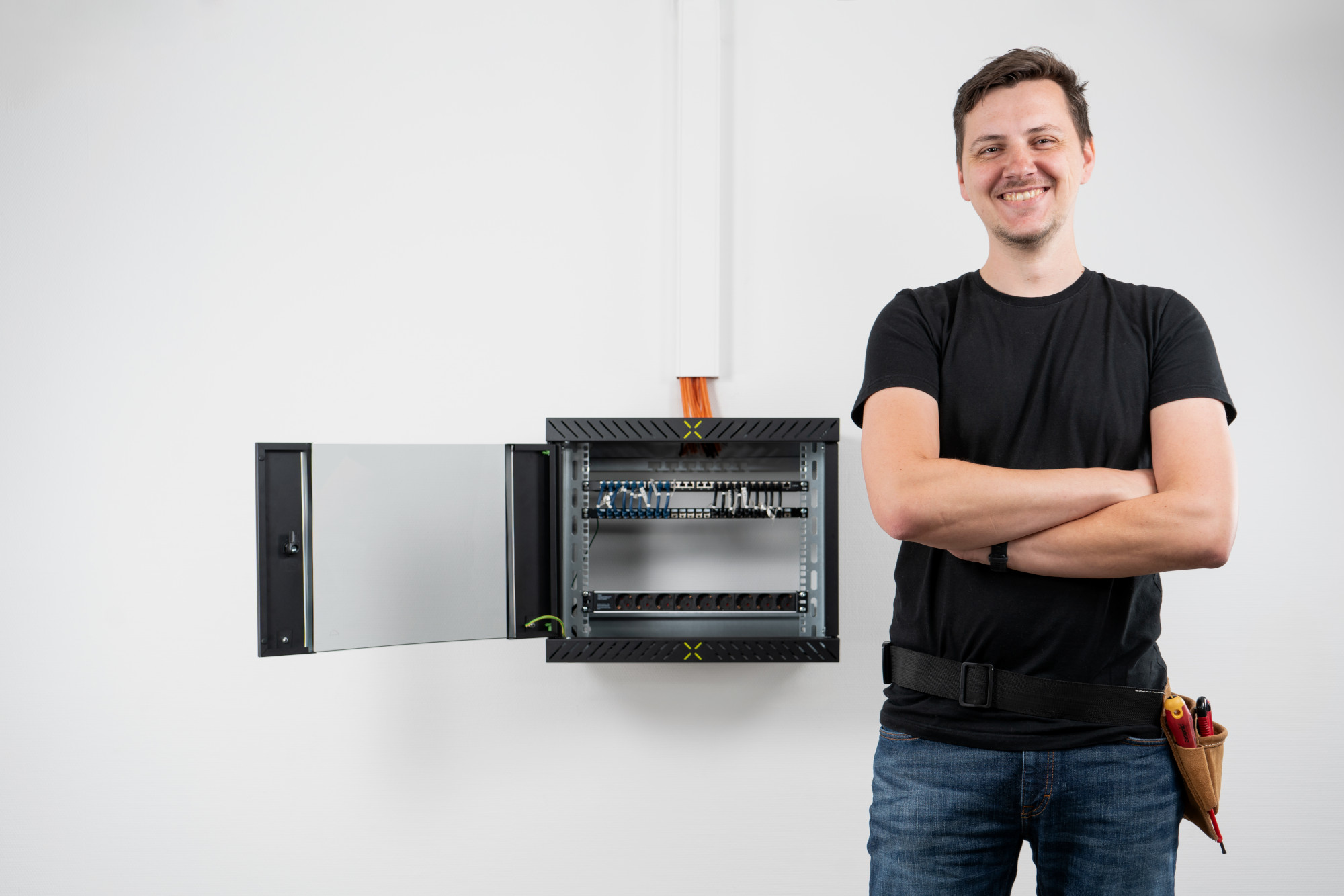Man posing in front of fully assembled X-Rack with door open Man posing in front of fully assembled X-Rack with door open