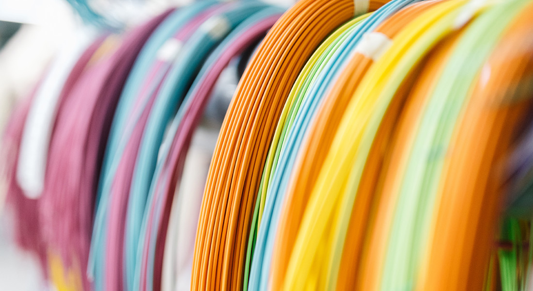 Several colored fiber optic cables next to each other in coils Several colored fiber optic cables next to each other in coils